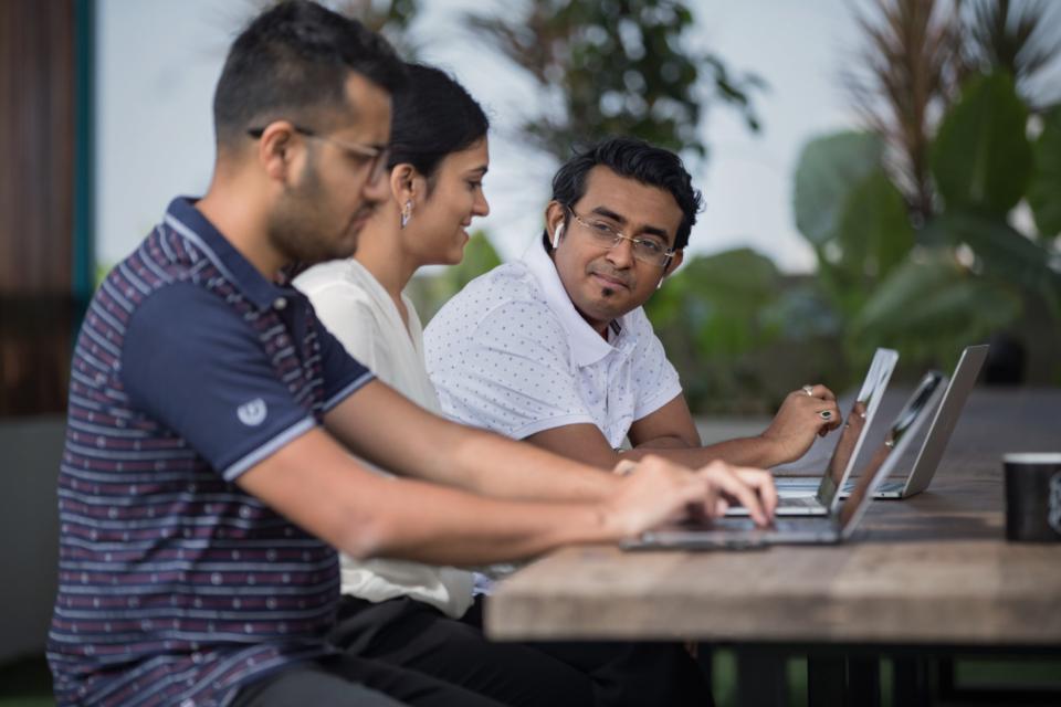 Engineers working together on laptops
